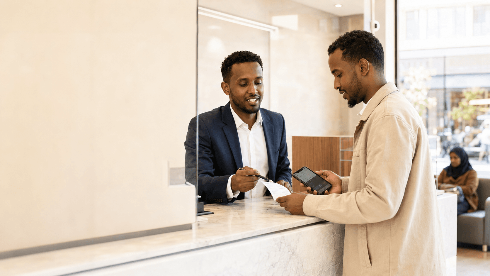 An agent assisting a customer at a counter